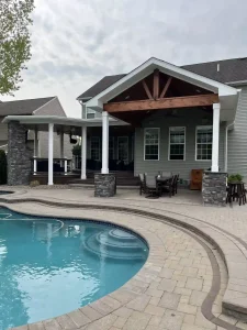 Wooden porch cover added onto a green home in Clarence, NY