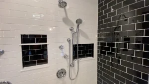 Chrome shower fixtures. Retro and elegant style luxury bathroom remodel by Stately Kitchen and Bath in Lockport, NY.