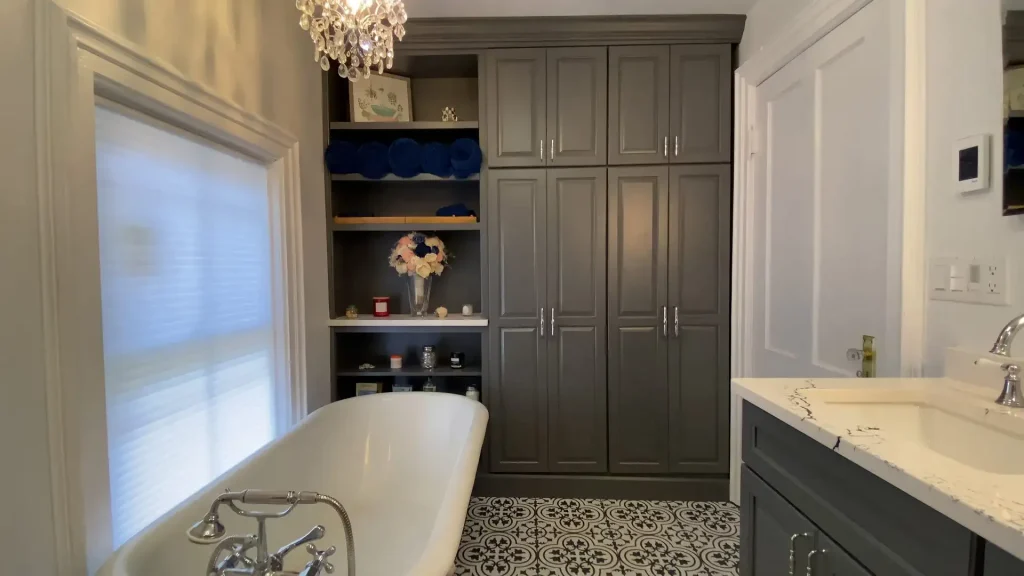 Clawfoot tub. Built-in storage. Retro and elegant style luxury bathroom remodel by Stately Kitchen and Bath in Lockport, NY.