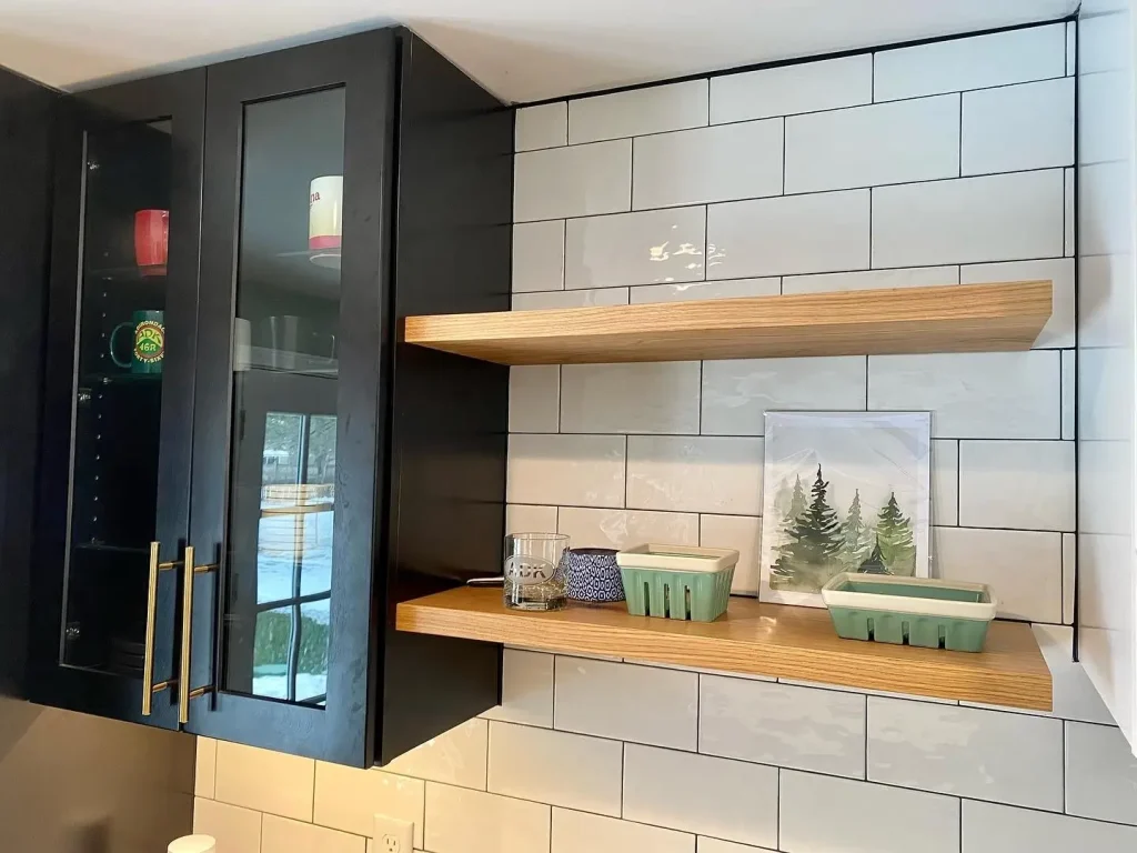 Cupboards and shelving. Trendy black and white kitchen by Stately Kitchen and Bath in Clarence Center, NY.