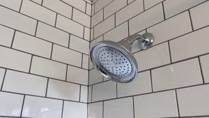 Chrome fixtures and expertly-installed subway tile by Stately Kitchen and Bath in Kenmore, NY.
