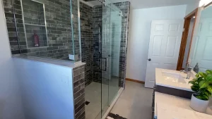 Glass shower door as part of a master bathroom addition by Stately General Contracting in Williamsville, NY.