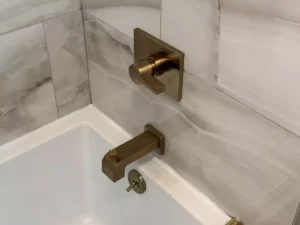 Brushed gold shower and bath fixtures, installed by Stately Kitchen and Bath in Clarence Center, NY.