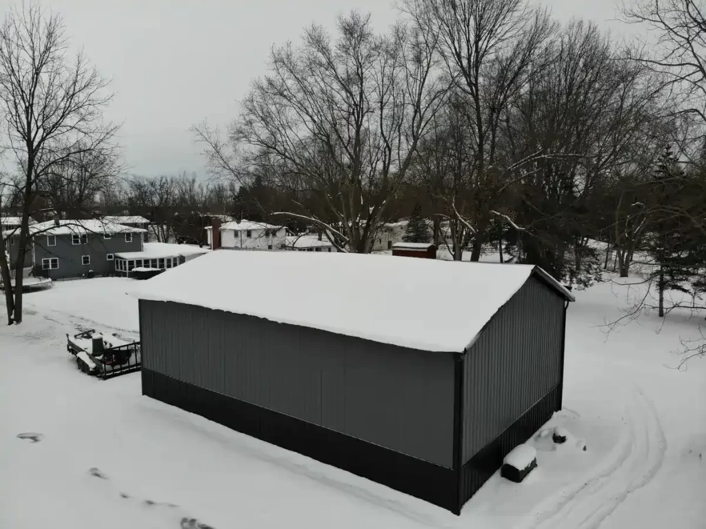 Elevated view of a Stately Pole Barn in East Amherst, NY, with a snowy roof, exemplifying sturdy winter resilience.