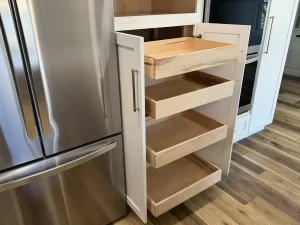 Custom kitchen storage solution with pull-out drawers by Reusch Woodworking, enhancing functionality in a remodeled Clarence, NY kitchen by Stately Kitchen & Bath.