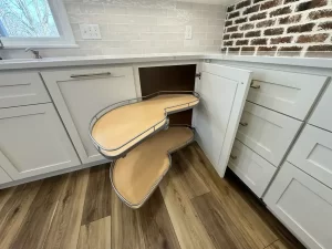 Efficient corner cabinet with pull-out storage shelves in a newly remodeled kitchen by Stately Kitchen and Bath in Clarence, NY.