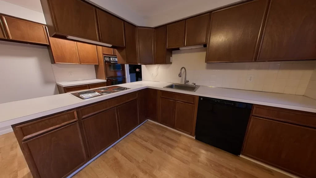 Clarence NY home kitchen before being remodeled with dark wood cabinets and limited space, ready for Stately Kitchen & Bath renovation.