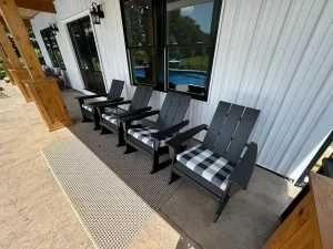 Front porch of the pool house addition in Akron, NY, with Adirondack chairs under the overhang, a project by Stately General Contracting.