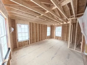 Interior view of the primary bedroom under construction by Stately General Contracting in Clarence, NY, highlighting framing and window installation.