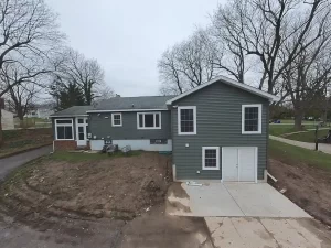 Stately General Contracting home addition in Clarence, NY, showcasing the newly constructed wing with an expanded primary bedroom suite and basement storage.