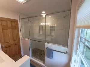 Clarence, NY home addition by Stately General Contracting, showcasing the elegant dual shower with glass doors and ample natural light.