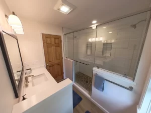 Stately General Contracting bathroom addition in Clarence, NY, highlighting the dual shower, vanity, and modern fixtures.