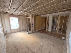 Primary bedroom construction with insulation installed on walls and ceiling in Clarence, NY home addition.