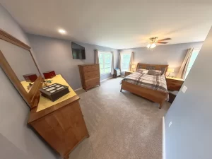 Interior view of the newly added primary bedroom suite by Stately General Contracting in Clarence, NY, featuring spacious layout and natural light.