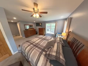 Interior view of the newly added primary bedroom suite by Stately General Contracting in Clarence, NY, showcasing spacious layout and modern amenities.