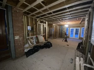 Framing stage of kitchen remodel in Amherst, NY, showing exposed beams and wiring by Stately Kitchen and Bath.