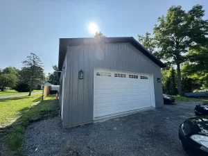 Complete view of the Stately Pole Barns project in Clarence, NY, showcasing the 24x36x10 building with a covered pavilion and modern design.