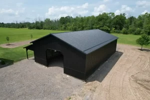 Overhead shot of a matte black pole barn built by Stately Pole Barns in Clarence, NY, featuring strong structural design with Everlast II Steel Panels and a spacious interior.