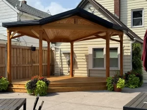 Wooden soundstage with steps leading up, positioned as the focal point of the Buffalo Olde Brewing beer garden for live entertainment.