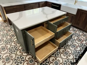 Completed remodel of Elma, NY, kitchen showing new layout with custom wooden cabinets, large central island, and matte black appliances.