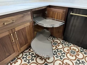 Elma, NY, remodeled kitchen island with open drawers and integrated storage, situated on a bold patterned tile floor.