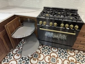 Elma, NY, remodeled kitchen island with open drawers and integrated storage, situated on a bold patterned tile floor.
