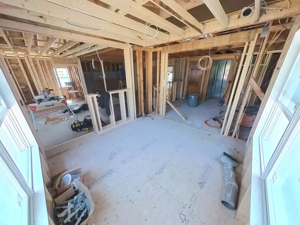 Interior framing underway for kitchen and bath addition in Amherst, NY, by Stately, showcasing structural layout and wiring setup.