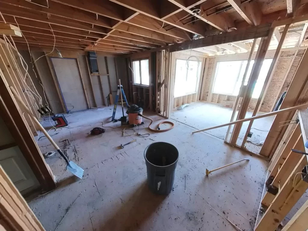 Framing of a new home addition in Amherst, NY by Stately General Contracting, with visible wiring and room partitions in progress.