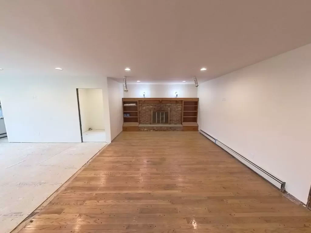 Brick fireplace and built-in shelves in expanded living area of Amherst, NY addition, adding character to Stately's remodel.