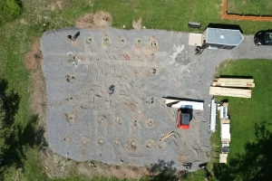 Top-down aerial view of Stately Pole Barn's post-frame building site, highlighting concrete foundation pier placements.