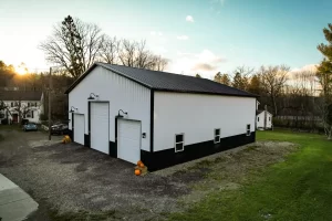 Angled view of white and black pole barn in Holland, NY