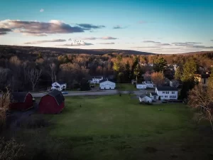 Aerial view of a Stately Pole Barns’ custom post-frame structure set against the rural landscape of Holland, NY.