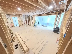 Framed walls and open-concept kitchen under construction during Clarence, NY remodel.