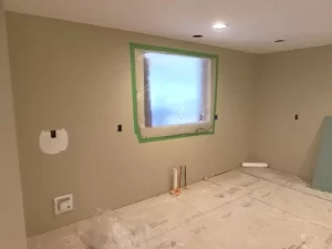 Kitchen under construction. Tape around the window indicates where a new, larger, window will be installed.