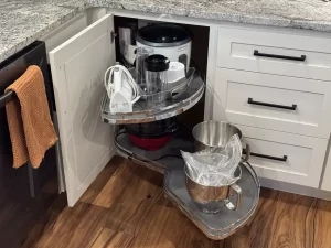 Corner cabinet with pull-out shelves, perfect for storing small kitchen appliances and cookware.