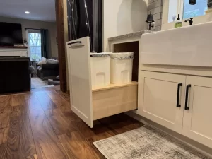 Pull-out waste bins discreetly placed under the kitchen sink for a clean and efficient layout.