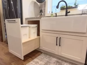 Pull-out waste bins discreetly placed under the kitchen sink for a clean and efficient layout.