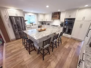 Fully remodeled kitchen with an island, modern appliances, and a farmhouse-style sink.