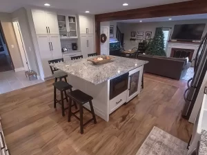 Open kitchen layout with a large central island connecting to a cozy living room in Clarence, NY.