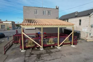 Construction of Ballyhoo Buffalo’s covered deck by Stately Pole Barns, showcasing frame structure in progress.