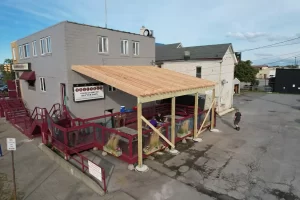 Closer look at Ballyhoo Buffalo’s patio under construction, with Stately Pole Barns building covered deck support frame.