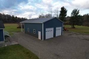 Post-frame building with overhead garage doors and vented roof, built by Stately Builders in Clarence Center NY.