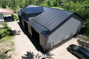 Three-bay pole barn built by Stately with corrugated steel siding and reverse gable for added headroom.