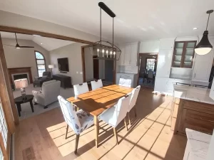 Amherst NY remodel with open-concept kitchen, dining, and living room featuring hardwood floors and custom cabinetry.