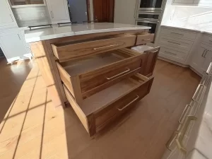 Amherst NY kitchen remodel showing custom walnut island drawers with soft-close slides and built-in organization.