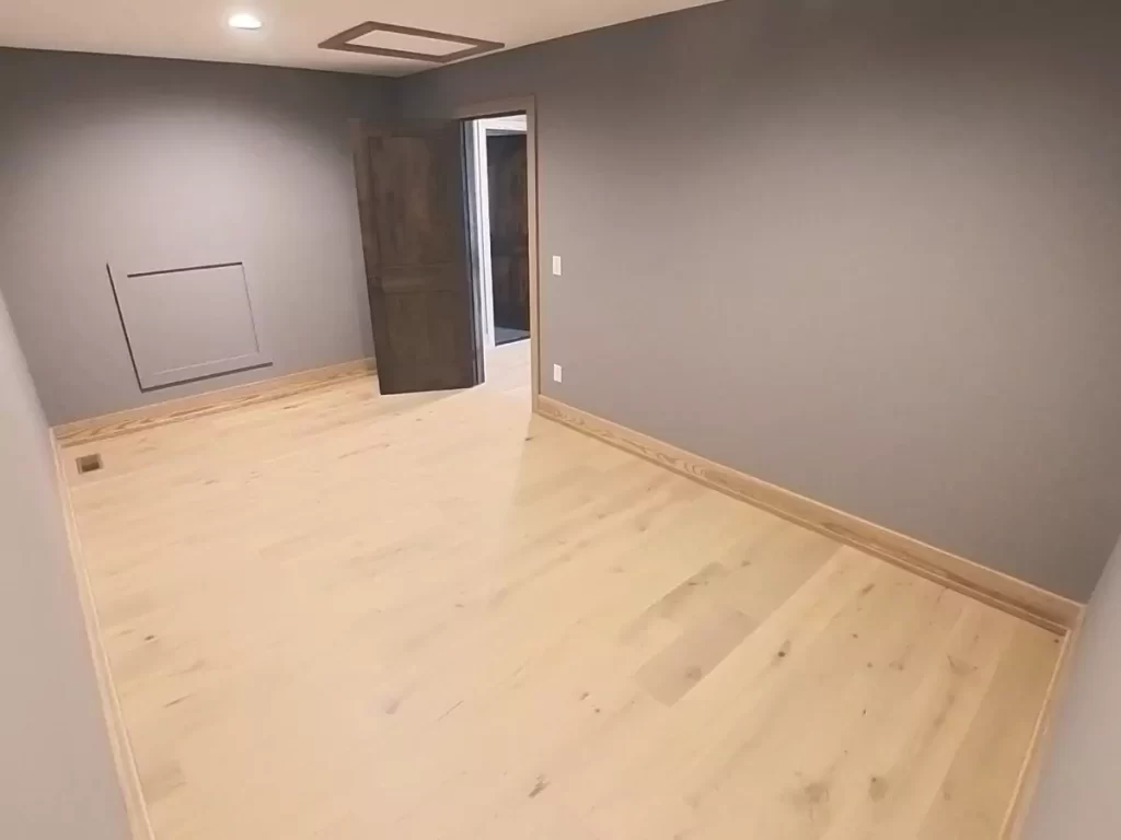 Spacious walk-in closet with light wood flooring, gray walls, recessed lighting, and an attic access panel in the ceiling.