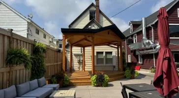 Wooden soundstage in Buffalo Olde Brewing beer garden, featuring elevated platform and sturdy wooden beams