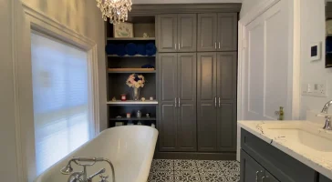Clawfoot tub. Built-in storage. Retro and elegant style luxury bathroom remodel by Stately Kitchen and Bath in Lockport, NY.