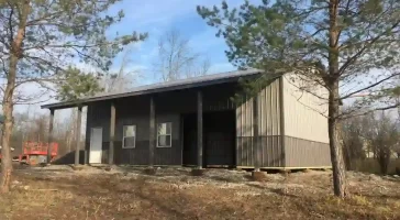 Sleek grey pole barn garage by Stately Post Frame in Grand Island, NY.