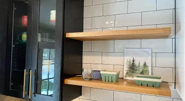 Cupboards and shelving. Trendy black and white kitchen by Stately Kitchen and Bath in Clarence Center, NY.